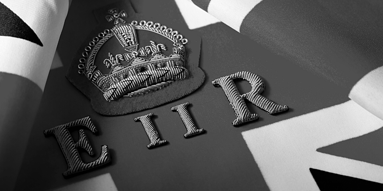 The image depicts an embossed crown above the letters 