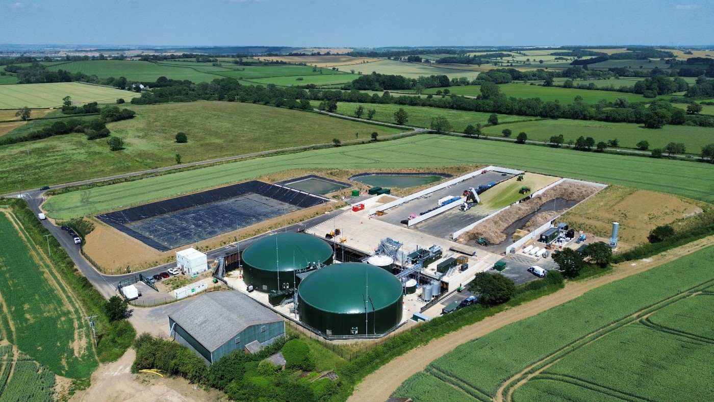 Aerial view of the Wormslade biomethane plant in Northamptonshire, featuring anaerobic digestion tanks and processing facilities surrounded by farmland.