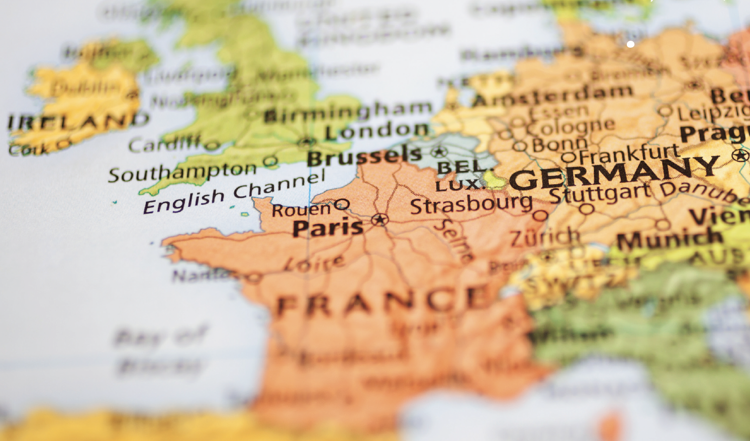 Close-up map of Western Europe highlighting orange France and Paris, bordered by Belgium, Germany, Spain, and the English Channel.