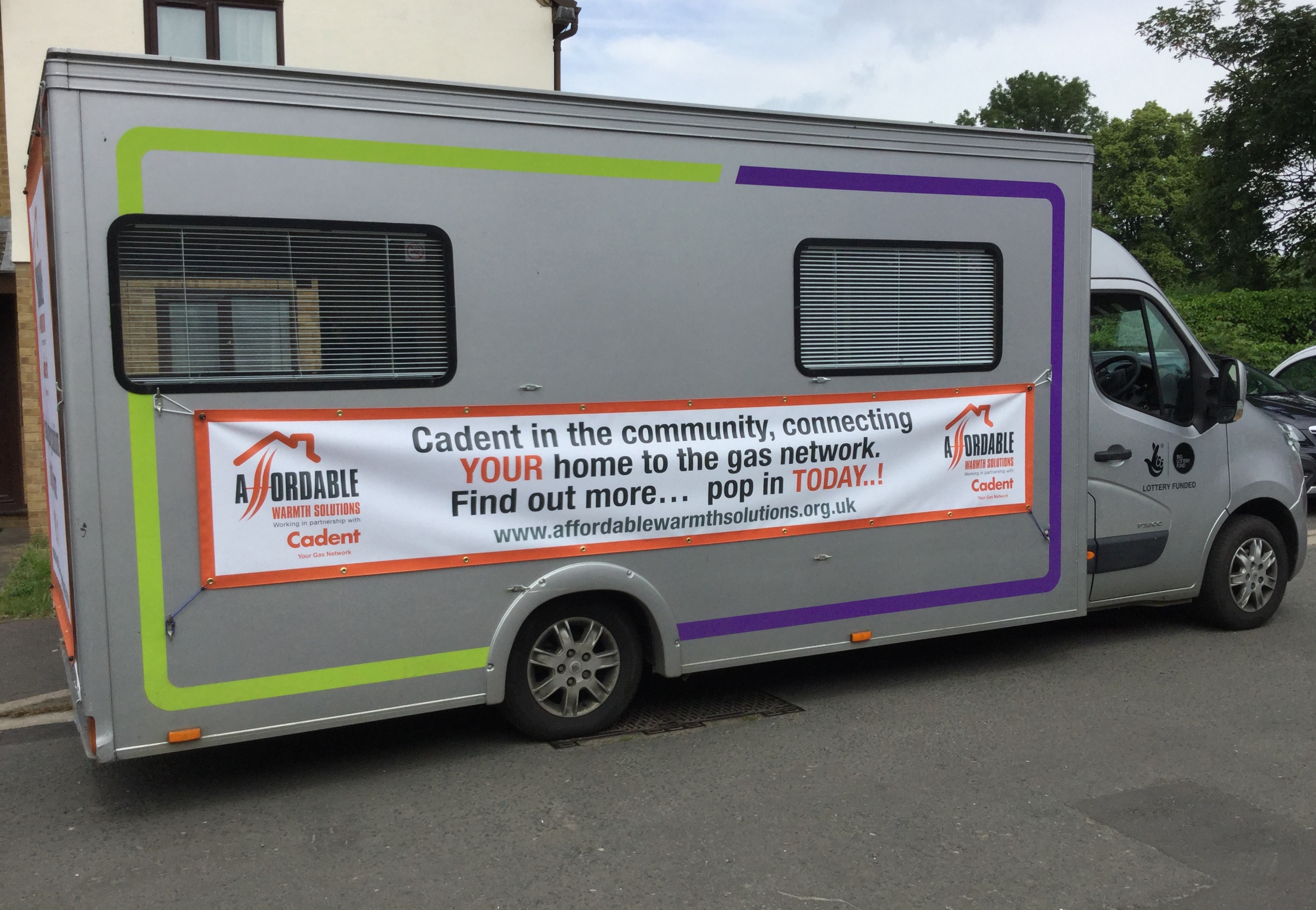 Cadent community outreach van displaying banner about connecting homes to the gas network, with website and contact details