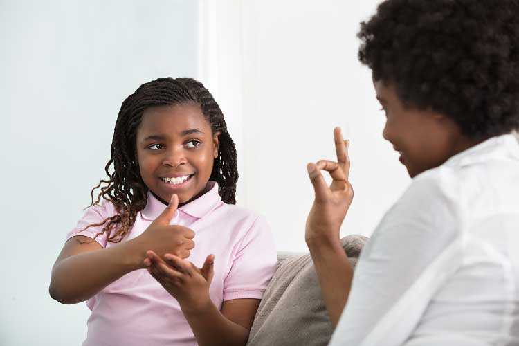 Deaf mother talking sign language with her daughter